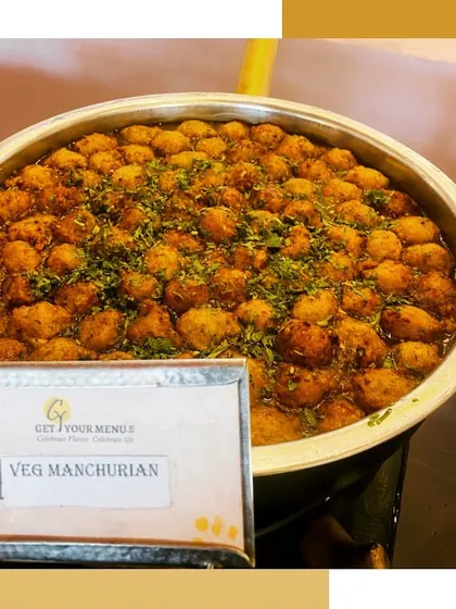 A large bowl of Veg Manchurian, a favourite Indo-Chinese dish, ready to be served at an event.