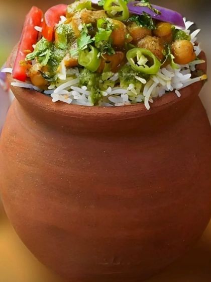 We serve traditional favourites with a special touch. This aromatic Chole Biryani is cooked and served in a classic clay matka, which enhances its flavour and adds to the rustic, authentic presentation.