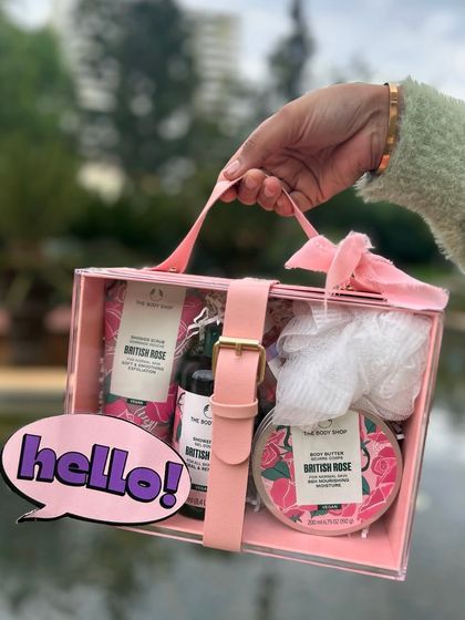 A chic and modern Rakhi gift set from The Body Shop, presented in a clear acrylic box with a stylish pink leatherette strap.