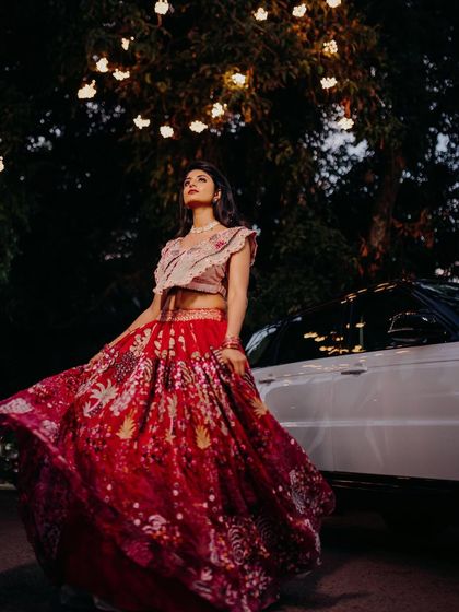 A beautiful, creative portrait. The upward angle and the lights in the trees create a magical atmosphere, and the bride's makeup looks perfect.