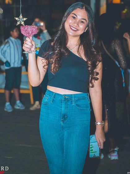 A guest with a festive cocktail at the Vivanta By Taj Christmas party.