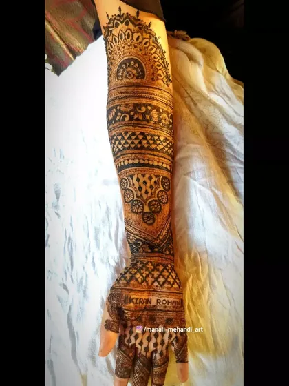 The full single-arm view of a bridal design, showing how all the different patterns come together. The bride's name is subtly included on the palm.