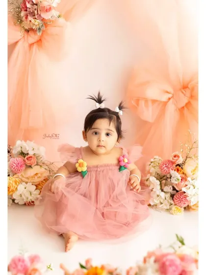Isn't she just a doll? This is a perfect example of the classic portrait part of my session. In a beautiful dress against a soft, floral backdrop, her personality shines through. These are the timeless photos that capture just how little they are at one.