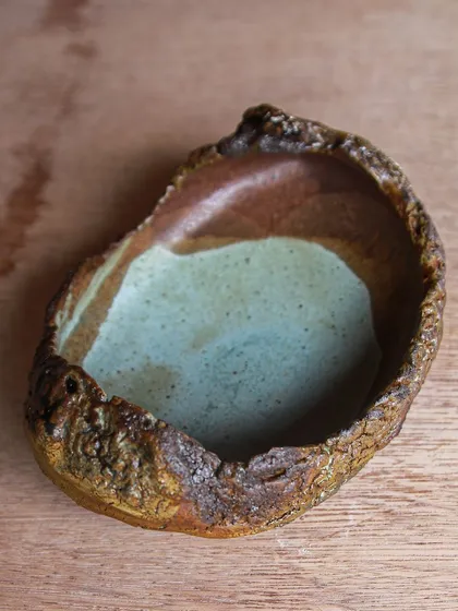 This small platter has a beautiful, painterly surface created by layering different glazes. It's a piece that is both functional and decorative.