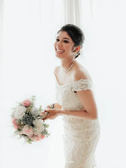 A candid moment of laughter, this bright and airy portrait captures the bride's genuine happiness.