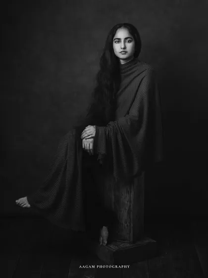 The black and white version of this artistic portrait emphasizes the form, texture, and the subject's pensive mood.
