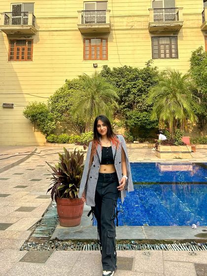 A confident pose by the pool. This is a great example of a stylish, non-swimwear look for a resort or hotel setting.