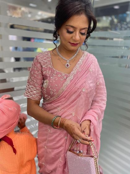 This client is ready for a special event with her elegant updo and professional makeup. We created a soft, romantic hairstyle that complements her beautiful saree and jewelry.