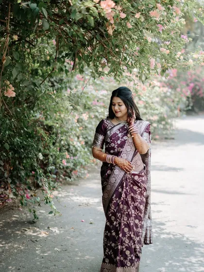 A lovely candid shot of the bride-to-be, captured in soft, natural light during her outdoor engagement session.