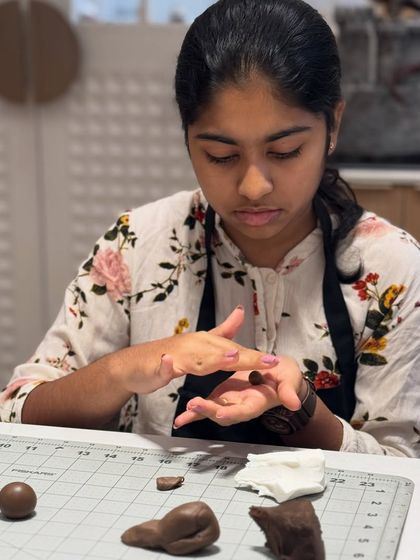 It’s all in the details. This young pastry artist is completely absorbed in rolling and shaping her fondant. I teach them the same basic techniques I use, just on a smaller, more playful scale.
