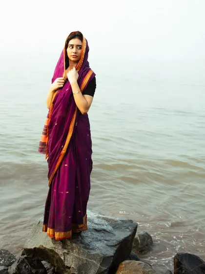 A thoughtful, looking-away pose that creates a sense of story and introspection. The overcast sky provides soft, even lighting.