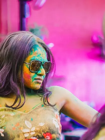 A candid shot of a guest lost in the music and colors of Holi. It's all about letting go and embracing the festive spirit.