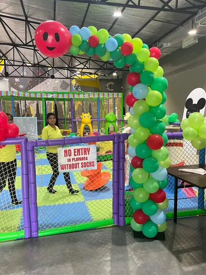 The entrance to our indoor play area decorated with a "Hungry Caterpillar" balloon arch.