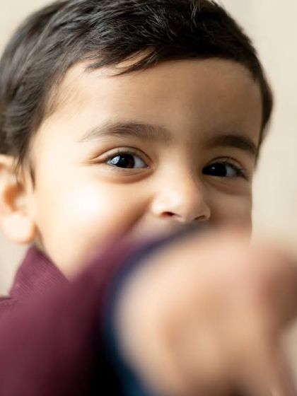 A close-up portrait capturing the bright, curious eyes of a young boy during his studio session.