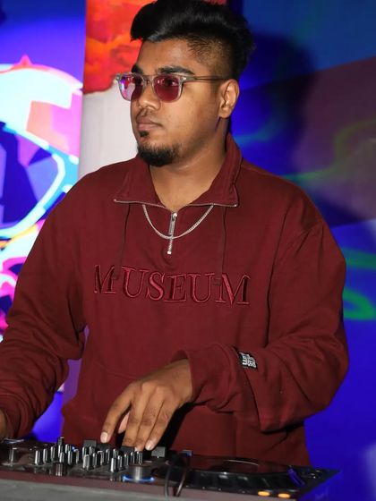 A profile shot of me at the console, with colorful pop art in the background. The venue's aesthetic often inspires the musical direction of the night.
