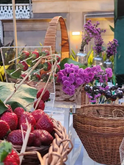A rustic and charming display of fresh strawberries and chocolate cake pops. We use creative arrangements, like this acrylic stand for strawberry skewers, to make our dessert tables visually engaging.