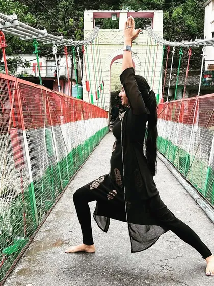 Yoga is a mirror to look at ourselves from within. Here I am in Warrior I on a bridge in Rishikesh, feeling the energy of the Ganga river below.