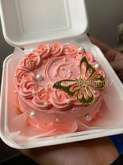 A duplicate of the pretty pink bento cake with a golden butterfly topper, perfect for Mother's Day.