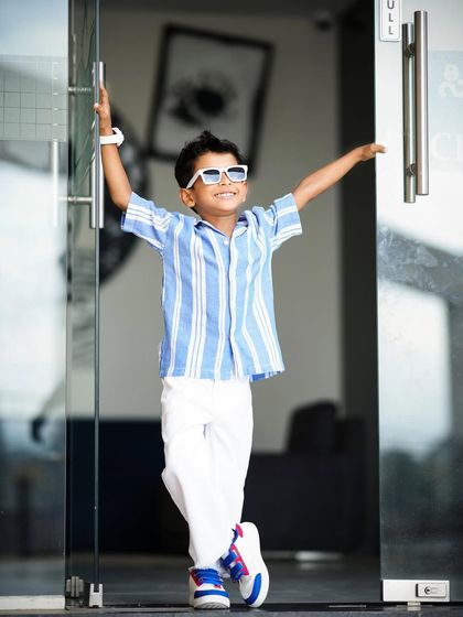 Making an entrance for his fifth birthday! This young boy's playful energy is perfectly captured in this fun, stylish shot.