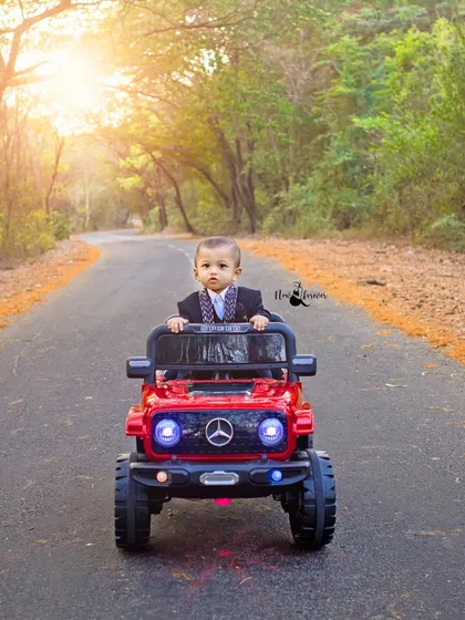 Hitting the road in style for a first birthday. This outdoor shoot captures the adventurous spirit of a one-year-old with beautiful, golden-hour light creating a cinematic feel.