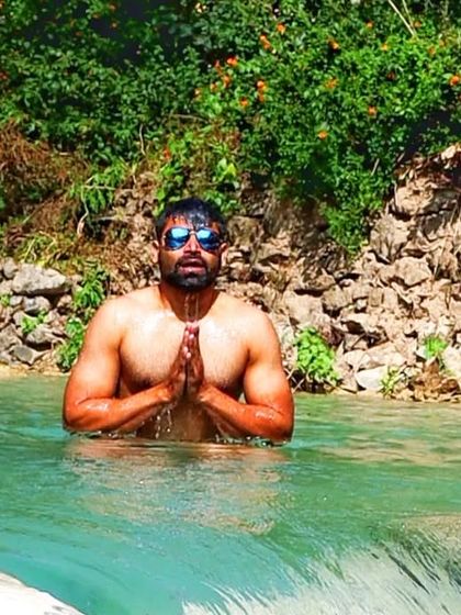 A moment of prayer and gratitude while immersed in the cool, flowing waters of the Ganga. This practice, known as a holy dip, is a way to purify the self and connect with the divine.