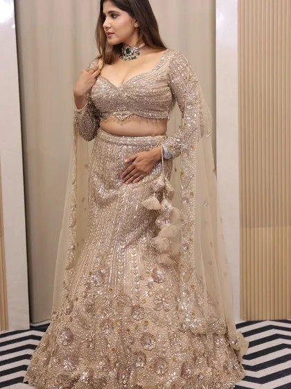 Another beautiful shot of the sequin lehenga, showing the full effect with the dupatta draped gracefully over the arm.