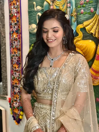 A beautiful, shimmery look in a gold lehenga, perfect for a sangeet or reception.