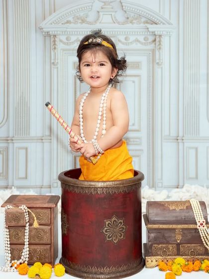 A full view of one of our classic Krishna theme setups, featuring beautiful ethnic props and a regal backdrop.