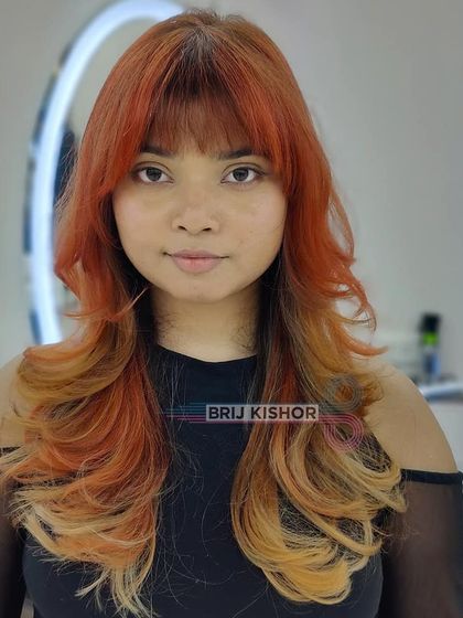 A full view of the Y2K-inspired orange and blonde hair color, a true throwback look.