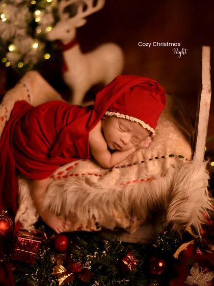 A cozy Christmas night. The warm glow from the fairy lights on the tree creates a magical and peaceful atmosphere for this newborn portrait.