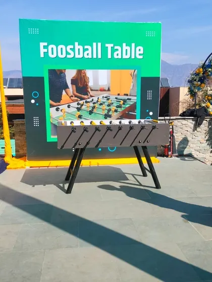 My modern Foosball table set up with a custom backdrop for a corporate event. It's a fast-paced game that's great for engaging guests.