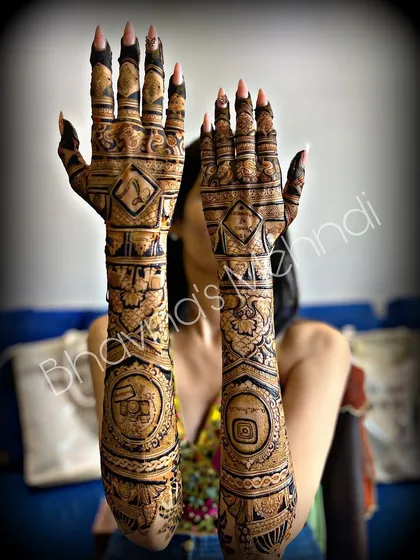 A full view of a unique bridal mehndi design. This set features bold geometric shapes and symbols, perfect for the bride looking for something modern and unconventional.