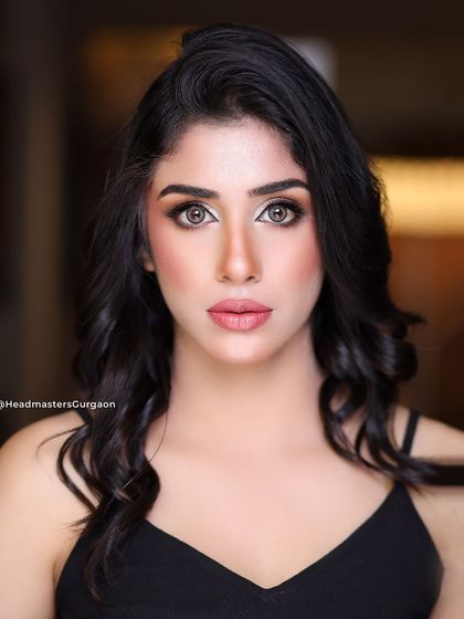 A direct, engaging shot of the model. The makeup focuses on creating a bright, open-eyed look with a healthy, natural-looking glow on the skin.