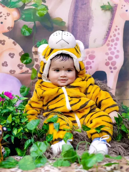 Welcome to the jungle! This adorable baby is dressed as a tiger in our fun and colorful jungle safari set.
