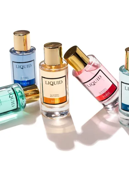A dynamic group shot of Liquid Perfumes, perfect for a website banner. The playful arrangement showcases the variety of colors and scents in the collection.
