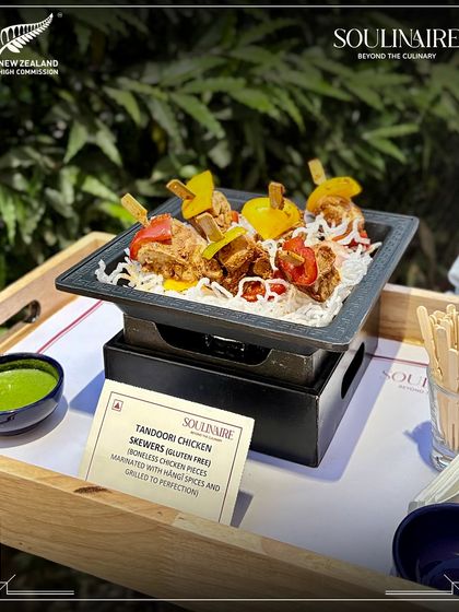 Tandoori Chicken Skewers being prepared on a mini grill at the New Zealand High Commission event. We offer interactive and engaging food presentations for our clients.