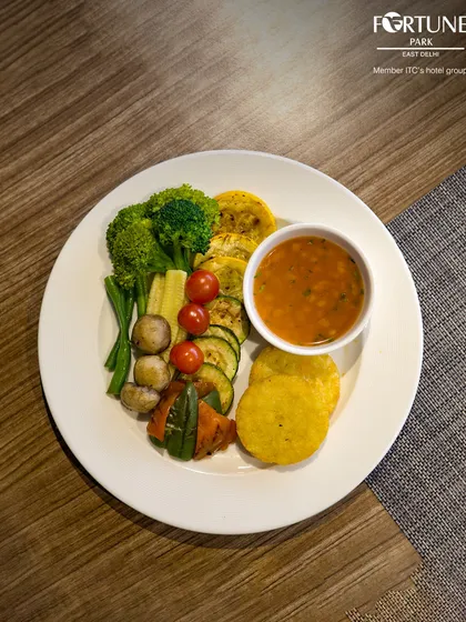 A plate of healthy grilled vegetables and lentil soup, showcasing the nutritious options available at our buffet.