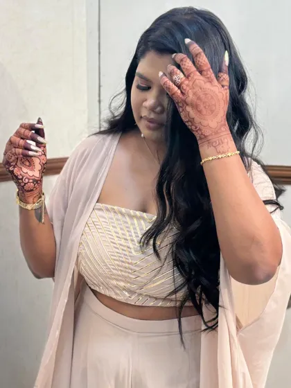 A beautiful client admiring her fresh mehndi. The joy on her face is what makes my work so rewarding.