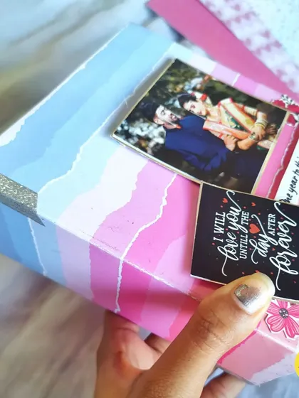 A close-up of the custom-designed album cover, showing the torn paper effect and glitter details.