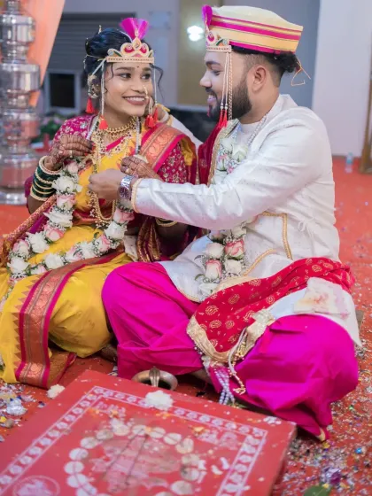 A candid moment of interaction between the bride and groom during their Maharashtrian wedding rituals.
