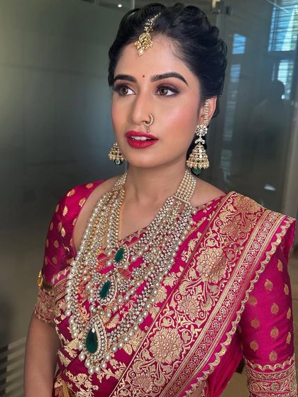 Royalty at first glance. For her bangle ceremony, we chose a bold red lip and defined eyes to match the grandeur of her Sabyasachi saree.