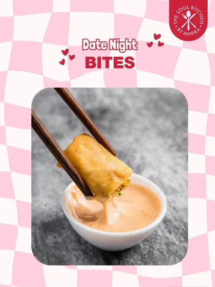 A crispy spring roll being dipped into a creamy sauce, another perfect bite-sized appetizer for a special evening.