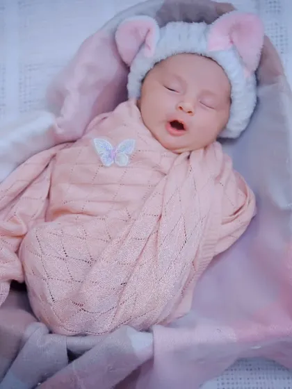 A tiny yawn from a sleeping newborn. These are the fleeting, adorable moments we love to capture during a session.