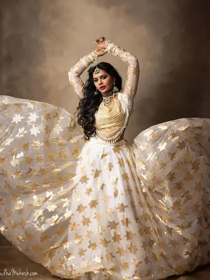 Let's create some magic for your pre-wedding shoot or sangeet. This oxidized silver-finish jewellery offers a bold and unique look, pairing beautifully with this white and gold lehenga. I love helping you style unconventional looks.