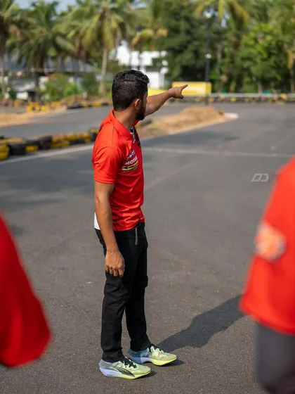 Pointing out the ideal racing line during a track walk. These small details make a huge difference in lap times and safety.