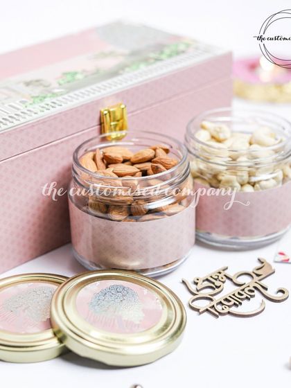 This elegant pink trunk box is one of my most popular items for Diwali. It's shown here with two jars of premium almonds and cashews, ready to be filled with more custom goodies.