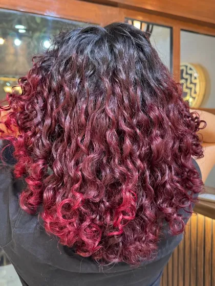 A beautiful gradient from natural dark roots to vibrant red ends.