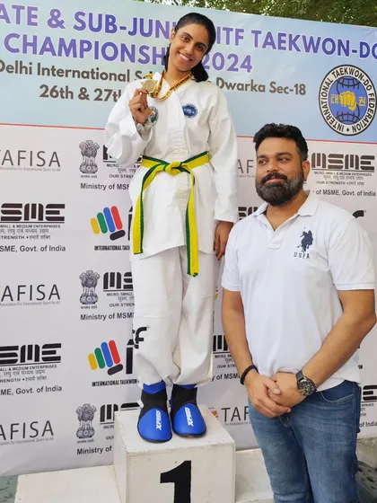 A student stands tall on the podium, a proud moment for her and her family.