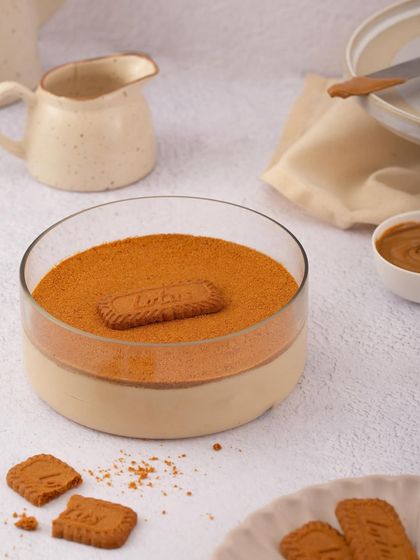 A clean, minimalist shot of my Biscoff Tiramisu, highlighting its distinct layers of cream and spiced cookie crumble.