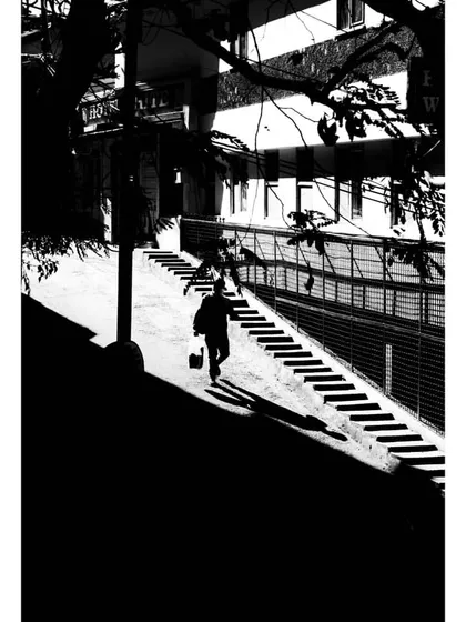 a high-contrast street photo focusing on shadows and light. this is a great example of using negative space to guide the eye, a key principle in clean ui design.
